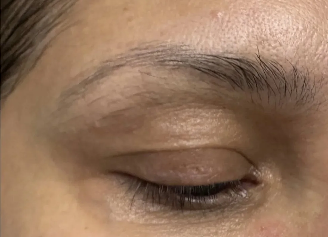Close-up of an eyebrow and eyelid area, eyes closed